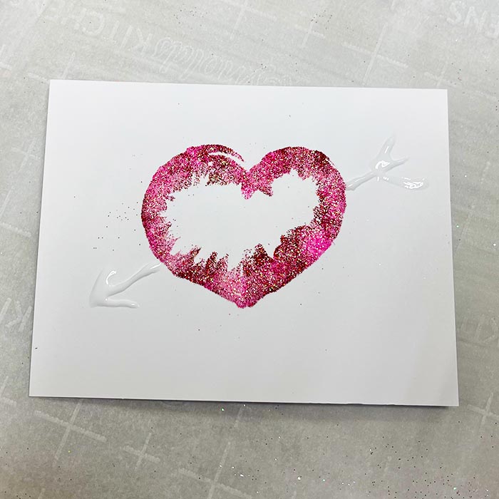Adding arrow to heart with glue bottle