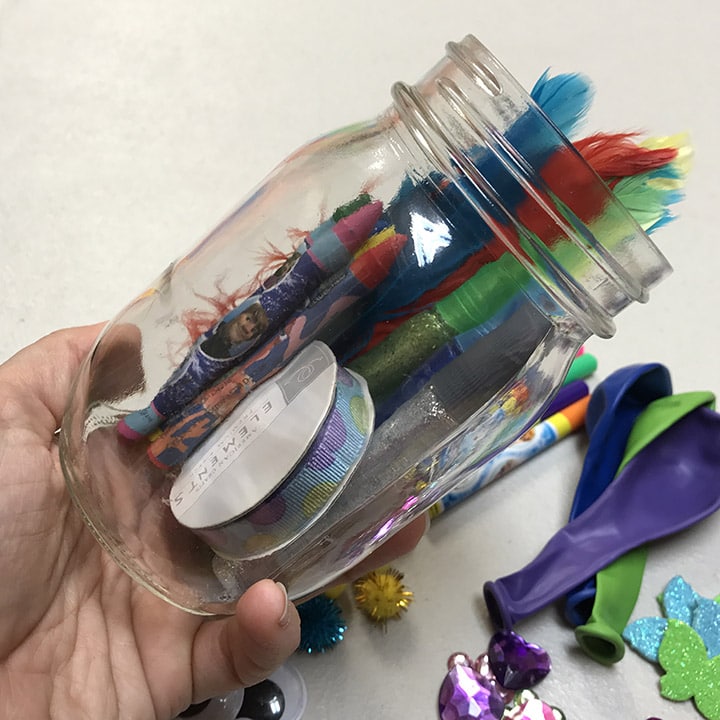Mason Jar Is Tilted To Fit All Craft Supplies In It