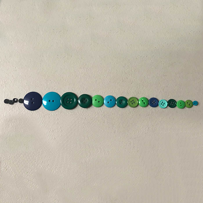 Laying out buttons for tree Christmas ornament