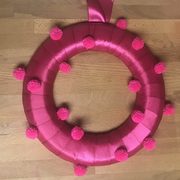 First pom poms on Valentine Pom Pom Wreath