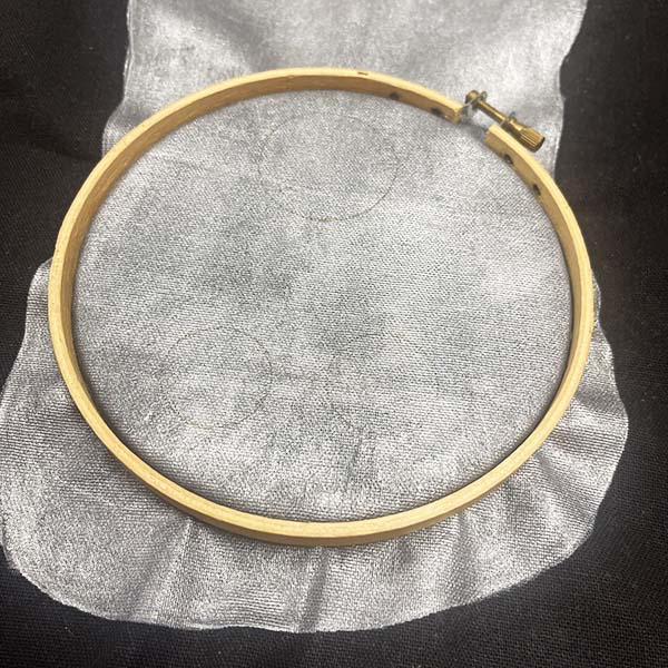 Placing embroidery hoop on bag