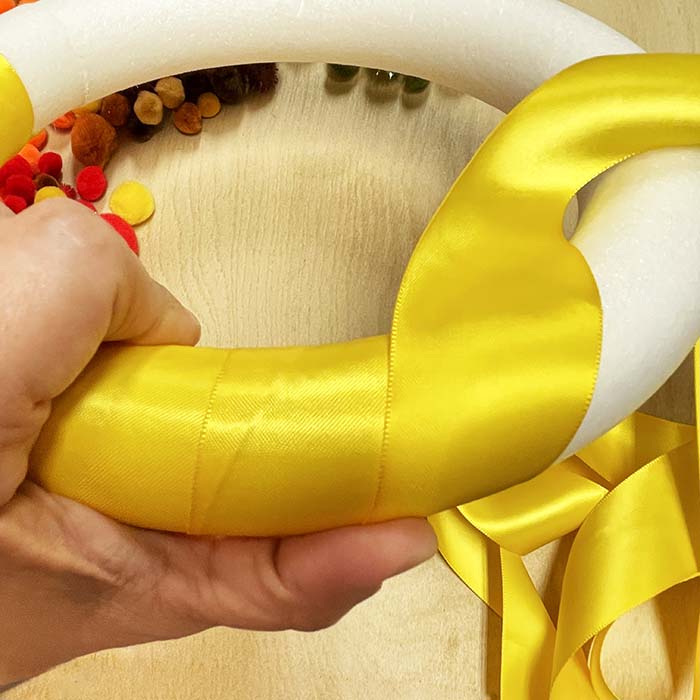 Wrapping ribbon around styrofoam wreath