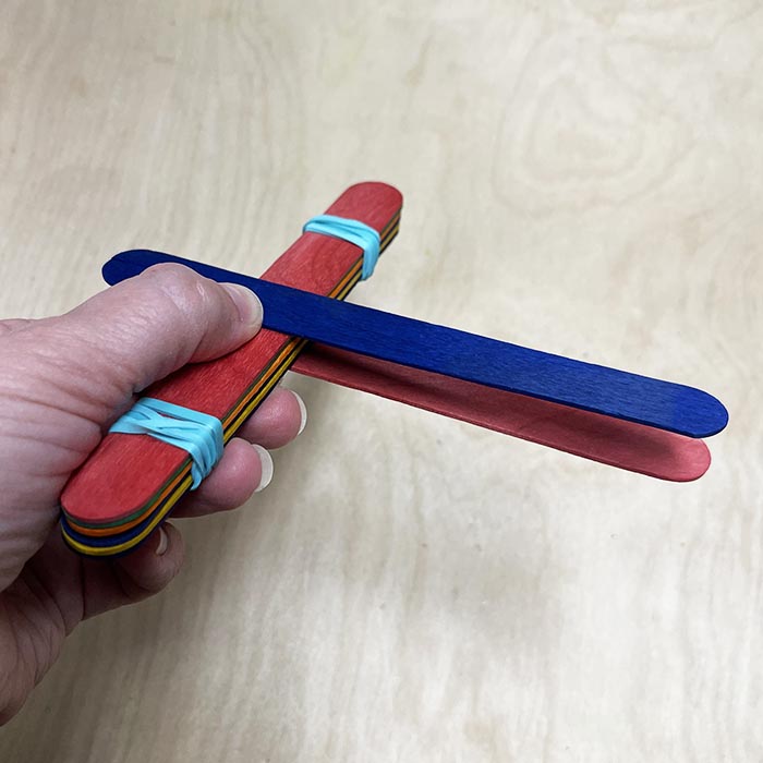 Adding Popsicle sticks for throwing arm of catapult