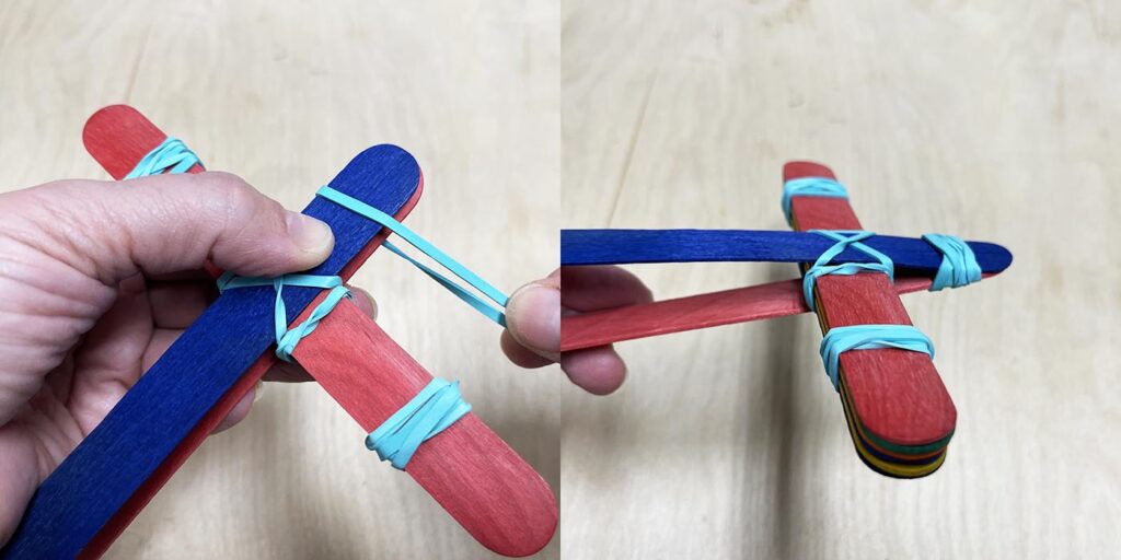 Rubber banding catapult arm