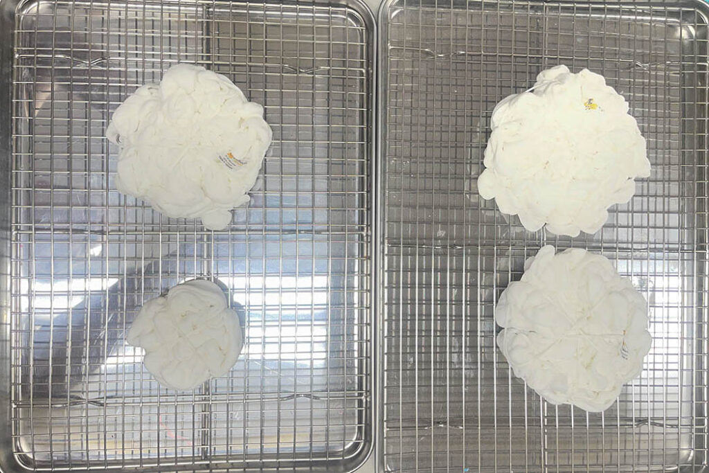 Placing baby items on trays for ice dyeing