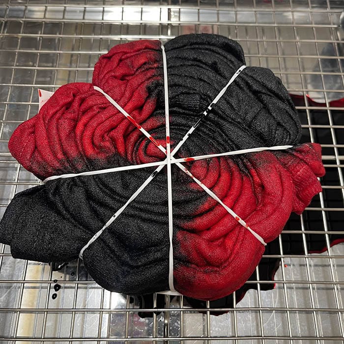 Dyeing the spider tie dye pattern with black and red