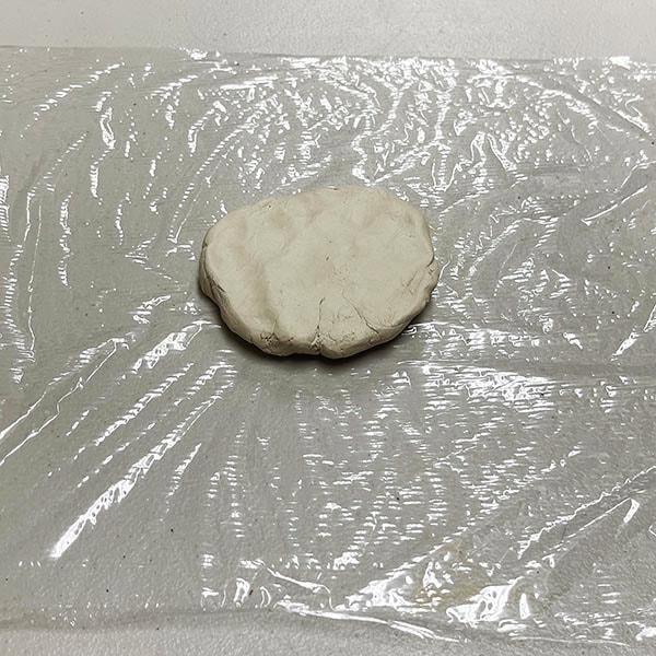 Clay on plastic wrap for rolling out