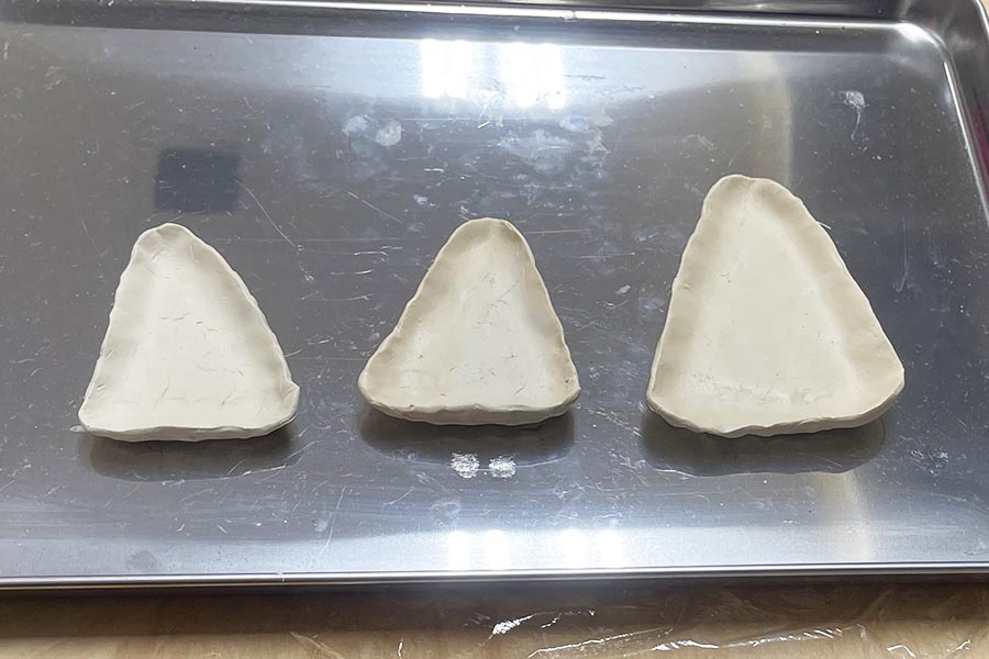 three candy corn dishes shaped and drying
