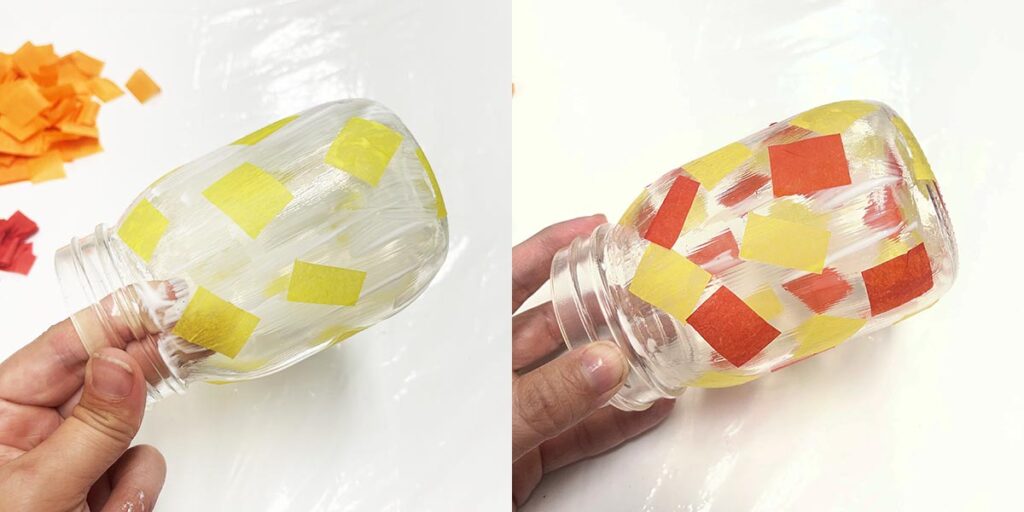 Adding pieces of yellow and red tissue paper to mason jar